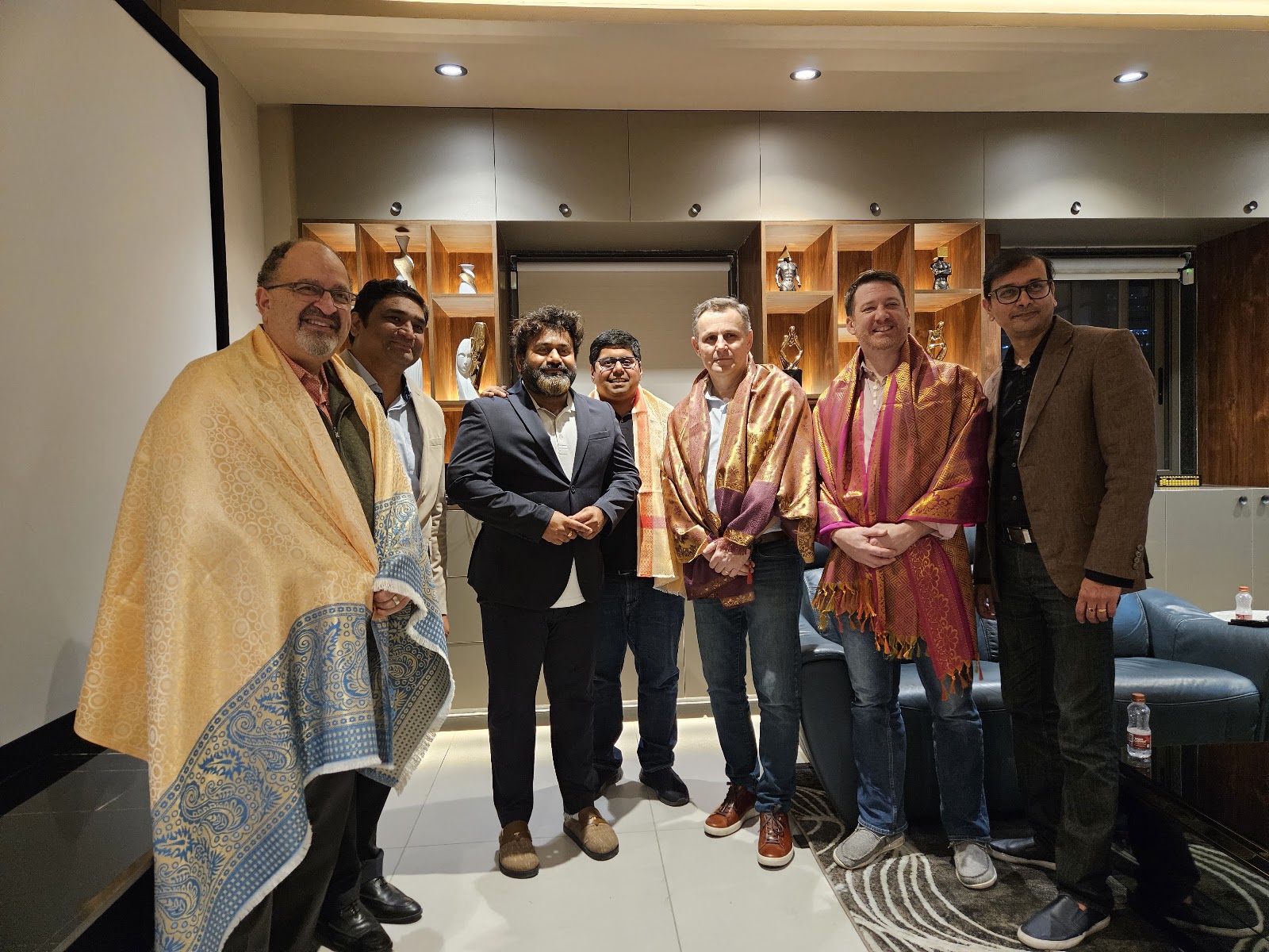 Mission group photographed in an indoor meeting setting during the stated India mission
