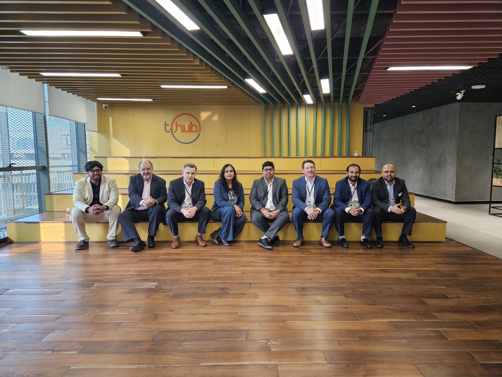 Mission group seated beneath T-Hub signage