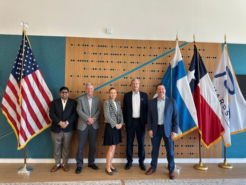 Participants pictured in front of United States, Finland, Texas, and Richardson flags at Startup Runway