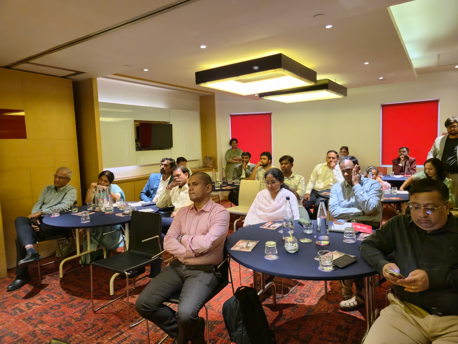 Attendees seated in a program setting during the stated mission