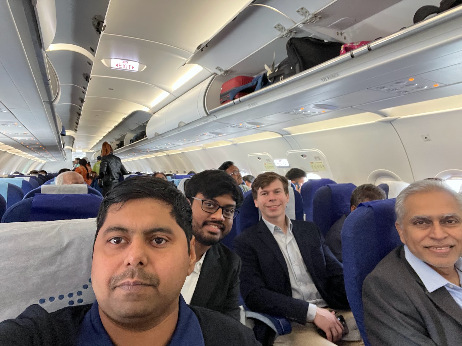 Mission participants seated on a flight