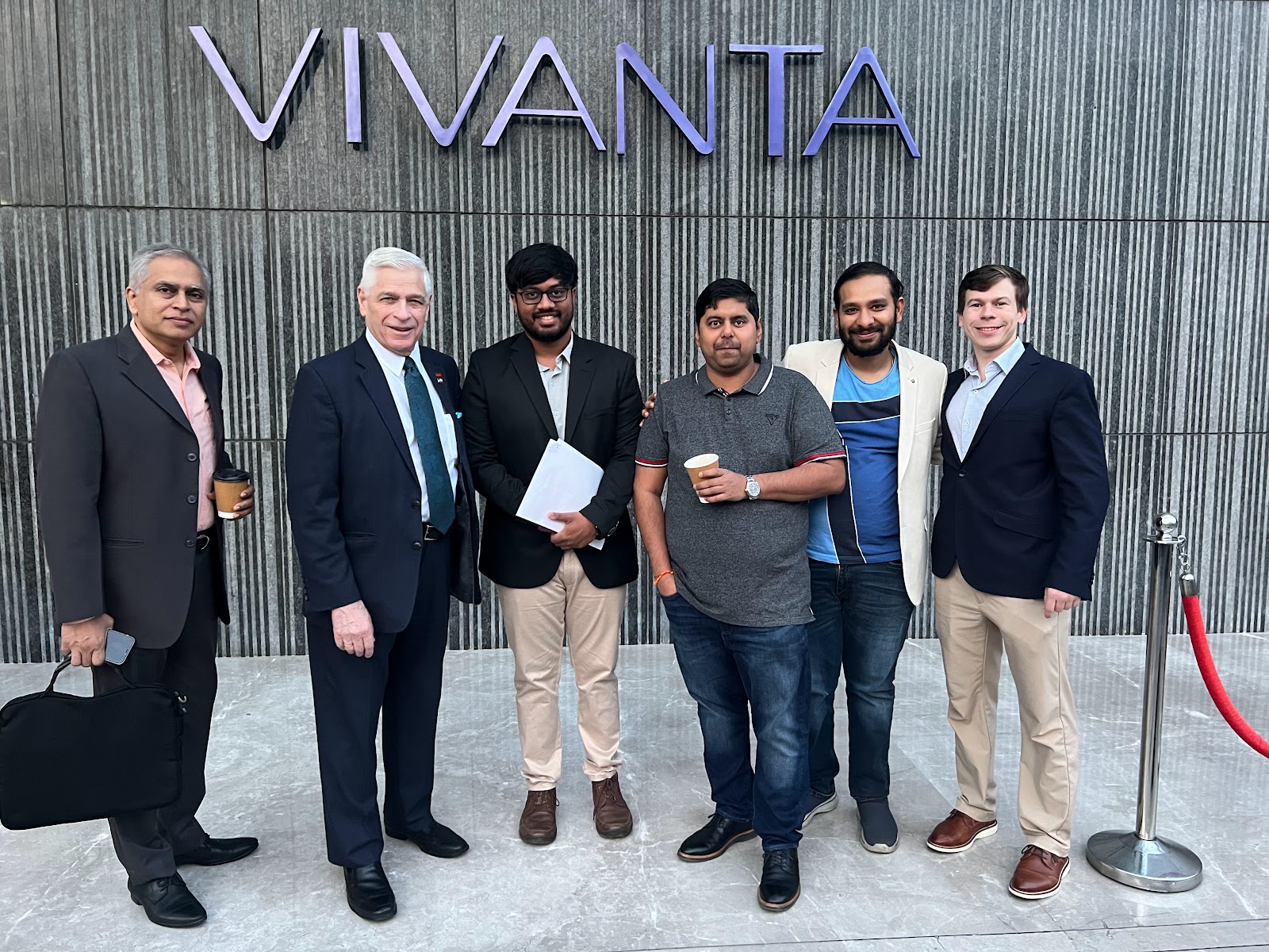 Mission group pictured in front of Vivanta signage