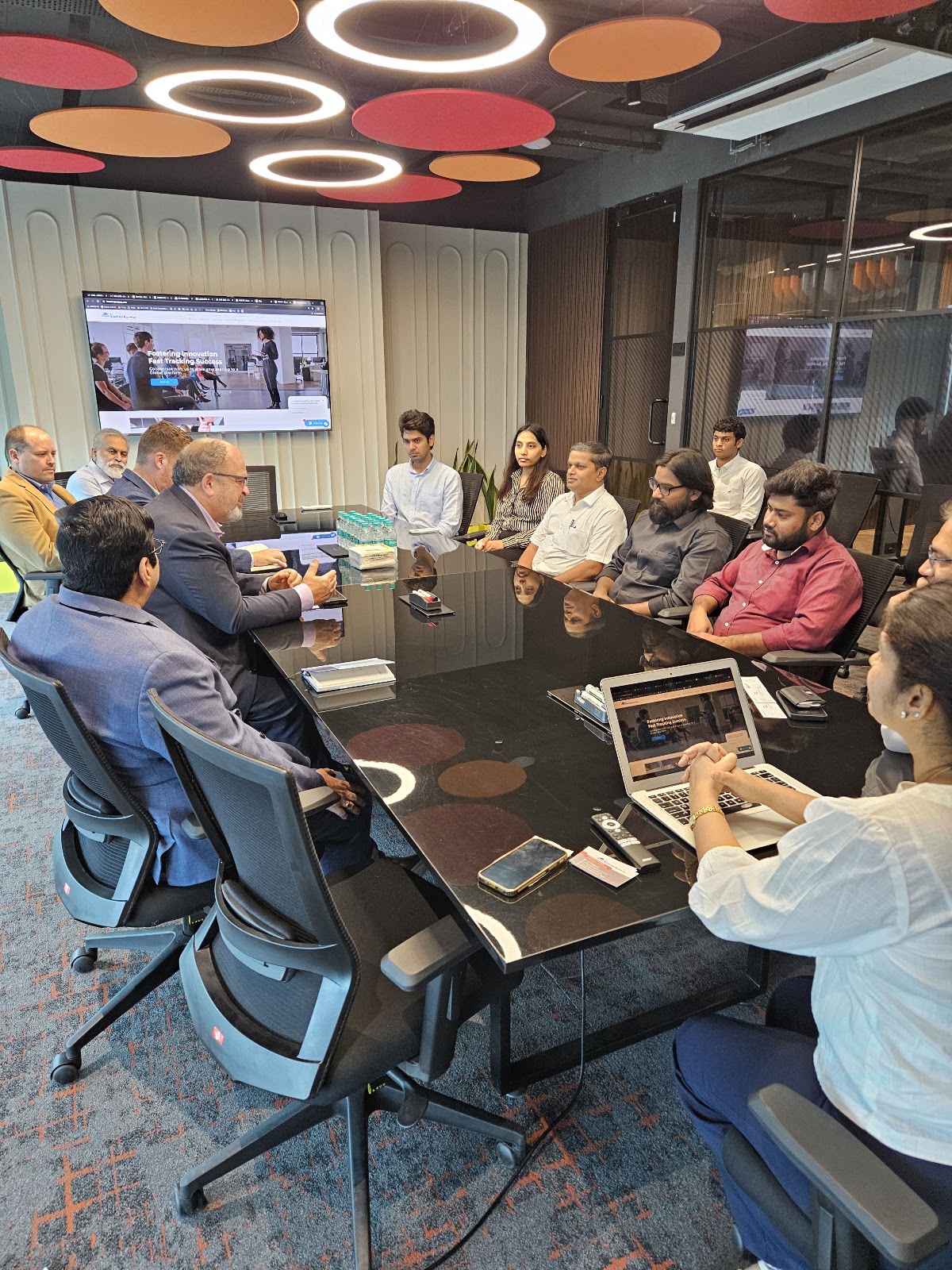 Mission participants gathered around a meeting table